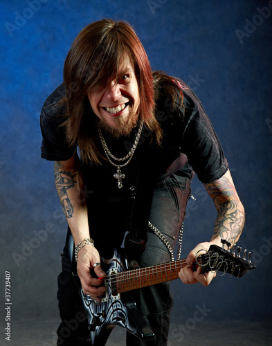 Photo: Brutal man playing electric guitar Brutal man playing electric guitar