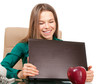 Photo: Beautiful woman office worker with laptop and apple Beautiful woman office worker with laptop and apple