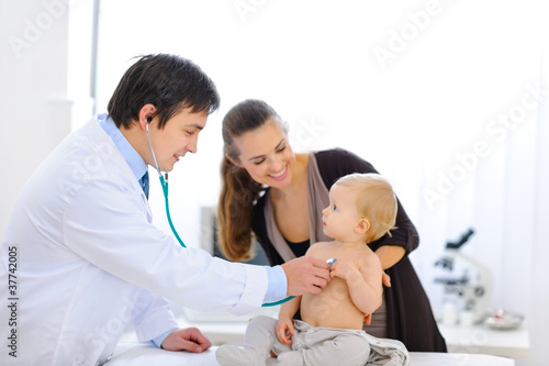 Photo: Surprised baby being checked by a doctor using a stethoscope Surprised baby being checked by a doctor using a stethoscope