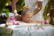 Happy young woman smiling during massage in spa