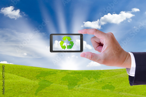 Photo: business man hand holding mobile phone and recycle sign business man hand holding mobile phone and recycle sign