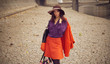 a beautiful young girl in a bright orange suit