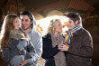2 junge Pärchen am Weihnachtsmarkt trinken Glühwein
