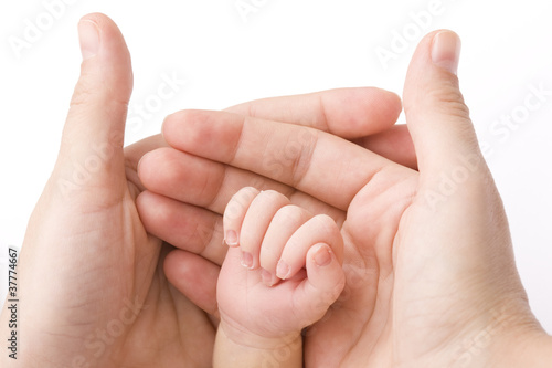 Photo: Close-up of baby's hand holding mother's finger Close-up of baby's hand holding mother's finger