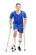 Photo: Injured soccer football player on crutches Injured soccer football player on crutches