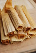 Chicken Tamales rolled in corn husks in a stack Chicken Tamales rolled in corn husks in a stack