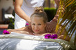 Photo: Happy young woman smiling during massage in spa Happy young woman smiling during massage in spa
