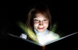 Young woman reading a magic book