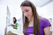 in the library - pretty female student with laptop and books