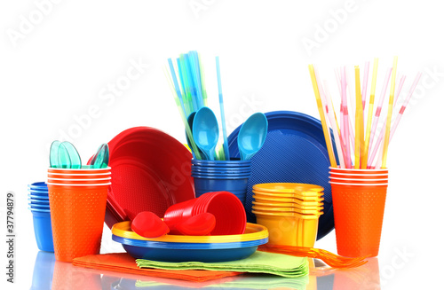 Photo: Bright plastic tableware and napkins isolated on white Bright plastic tableware and napkins isolated on white