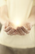 Male hands holding rays of glowing light