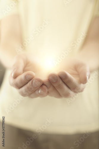 Photo: Male hands holding rays of glowing light Male hands holding rays of glowing light