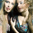 Fashiong portrait of two beautiful women with streaming hair loo