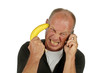 Man pointing his banana gun against his head while phoning