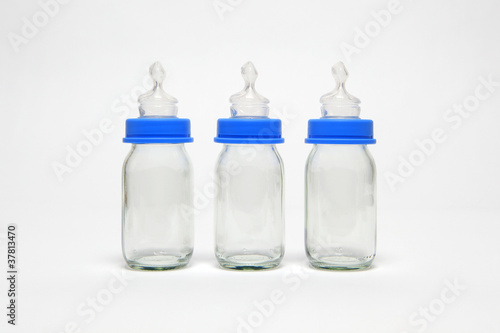 Photo: Three empty baby bottles in a row Three empty baby bottles in a row