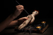 Voodoo doll girl pierced by a needle