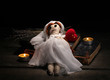 Voodoo doll girl-bride on a wooden table in the candlelight