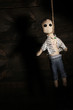 Hanged doll voodoo boy on wooden background