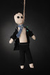 Hanged doll voodoo boy-groom on grey background