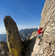 Rock climber clinging to a cliff.