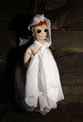 Hanged doll voodoo girl-bride  on wooden background
