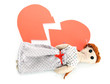 Voodoo doll girl on the broken heart isolated on white