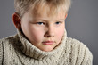 portrait of a young boy in the studio on a gray background