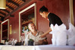 Photo: asian waitress talking with client in restaurant asian waitress talking with client in restaurant