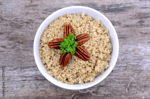 Photo: Overhead view of bowl of quinoa salad with pecans and parsley Overhead view of bowl of quinoa salad with pecans and parsley
