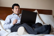 Hispanic businessman using laptop in his hotel room
