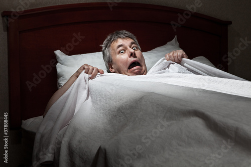 Photo: Man startled awake by intruder Man startled awake by intruder