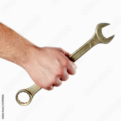 Photo: wrench in the man's hand wrench in the man's hand