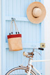 Old bicycle leaning against blue door.