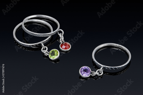 Photo: Silver ring with colored stones with reflection. Silver ring with colored stones with reflection.
