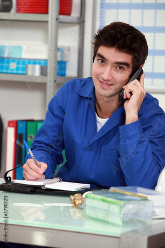 Photo: Worker with a phone and diary Worker with a phone and diary