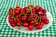plate on the green cloth, with juicy cherry