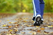 Photo: Woman walking cross country trail in autumn forest Woman walking cross country trail in autumn forest