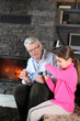 Little girl playing card game with granddad