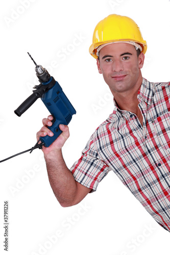 Photo: Tradesman holding an electric screwdriver Tradesman holding an electric screwdriver