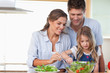 Family preparing a salad
