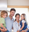 Smiling family standing up