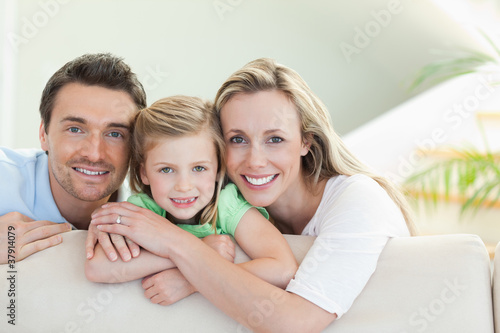 Photo: Parents with daughter on the couch Parents with daughter on the couch