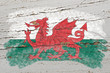 flag of wales on grunge wooden texture painted with chalk
