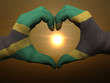 Heart and love gesture by hands colored in jamaica flag during b Heart and love gesture by hands colored in jamaica flag during b