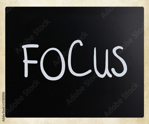 Photo: The word "Focus" handwritten with white chalk on a blackboard The word "Focus" handwritten with white chalk on a blackboard