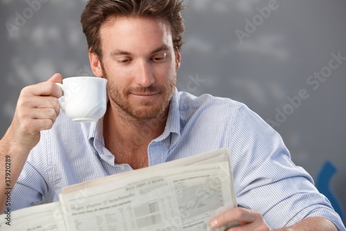 Photo: Handsome guy with newspaper Handsome guy with newspaper