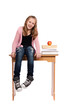 Schoolgirl sitting on desk with books Schoolgirl sitting on desk with books