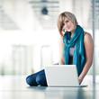 Pretty young female student with a laptop computer on college