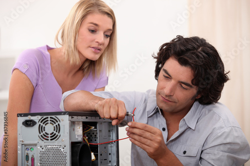 Photo: man repairing a computer man repairing a computer