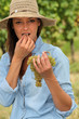 Woman eating grapes